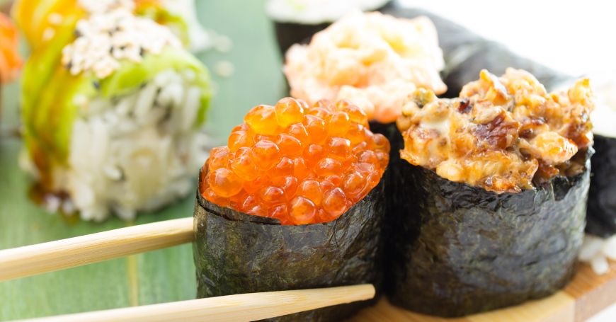 alcuni pezzi di gunkan, o gunkanmaki, su un piatto in un ristorante giapponese di sushi